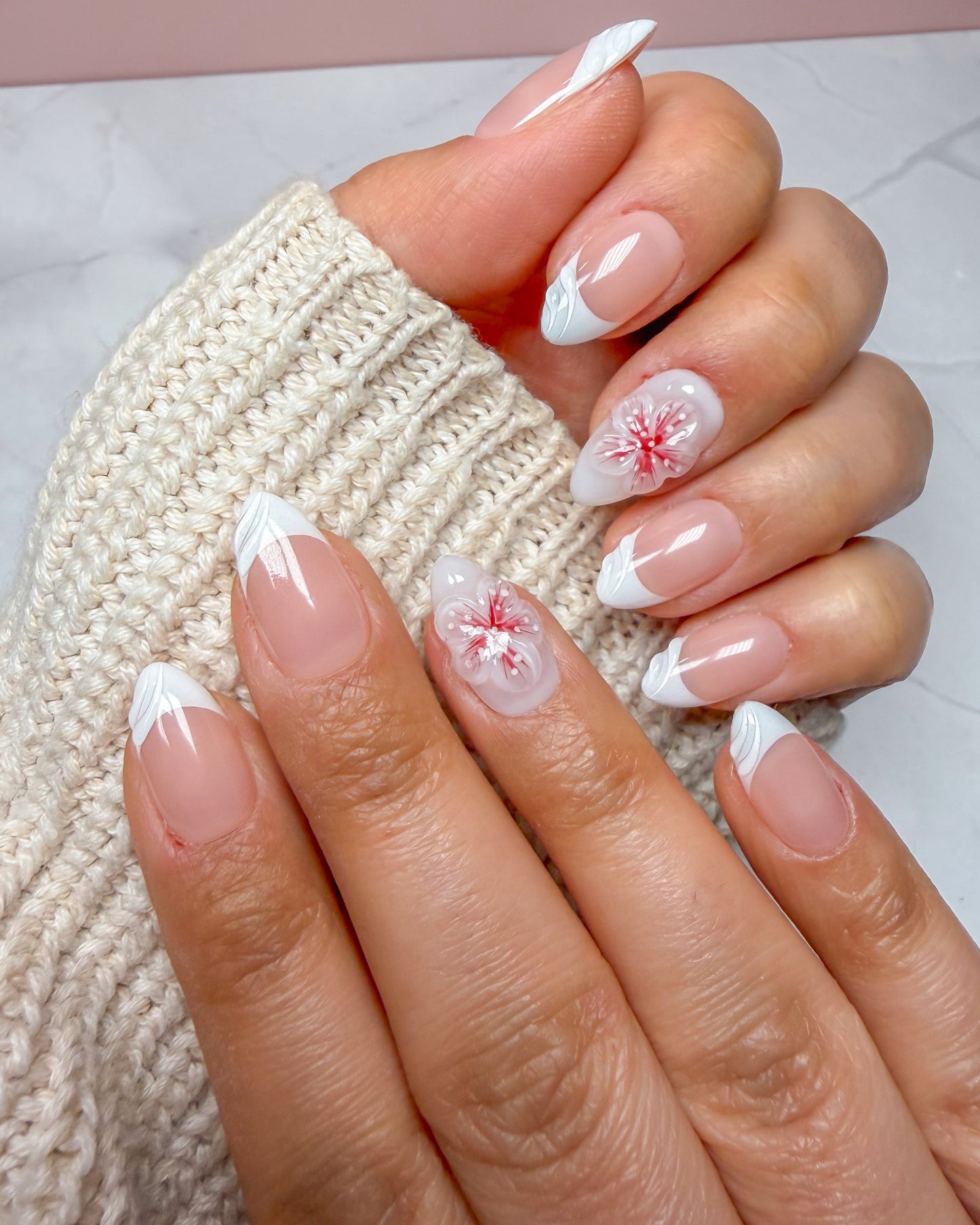 The romantic one.
Short length
Almond shape
Nude base with white French tips
Chevron tip design with swirl detail
3D floral accents in red & pink
Made for the romantic aesthetic.